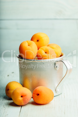 Mellow apricots in metal mug