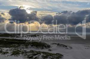 Amrum island, Germany: sun rays emerging through the dark storm