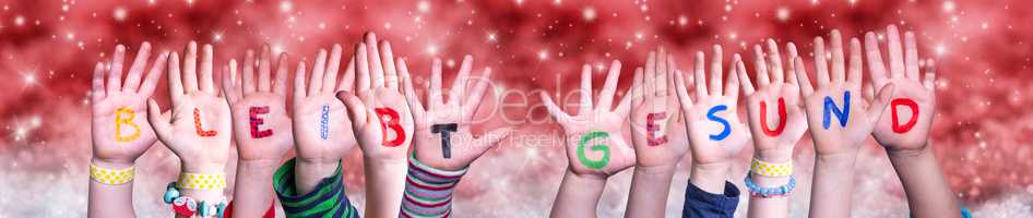 Children Hands Bleibt Gesund Means Stay Healthy, Red Christmas Background