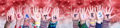 Children Hands Building Word Health First, Red Christmas Background