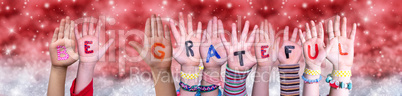 Children Hands Building Word Be Grateful, Red Christmas Background