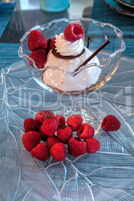 Dessert dish of cheesecake, shaved chocolate and raspberries