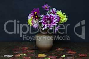 Bouquet of dahlias in a vase on a wooden table