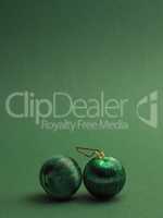 Green vintage Christmas baubles on a green background
