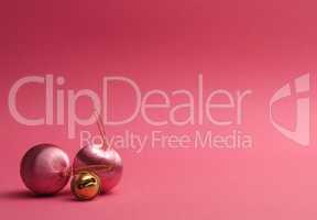 Pink vintage Christmas baubles on a pink background
