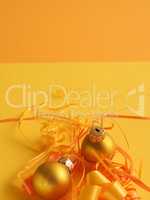 Golden vintage Christmas baubles on a yellow background