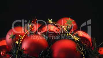 Red Christmas balls on a black background