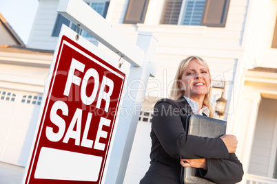 Female Real Estate Agent in Front of For Sale Sign and Beautiful