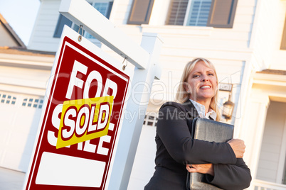 Female Real Estate Agent in Front of Sold For Sale Sign and Beau