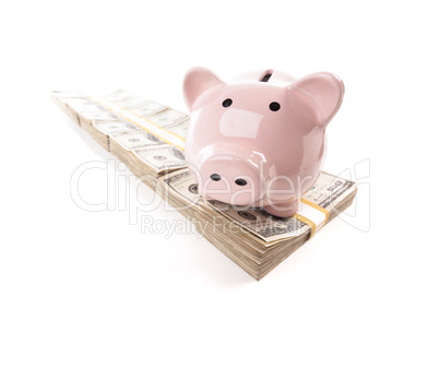 Pink Piggy Bank on Row of Hundreds of Dollars Stacks Isolated on