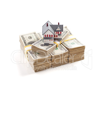Small House on Stacks of Hundred Dollar Bills Isolated on a Whit