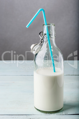 Bottle of milk with blue straw