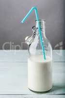 Bottle of milk with blue straw