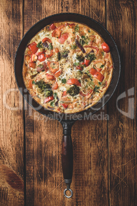 Vegetable frittata with broccoli in cast iron pan