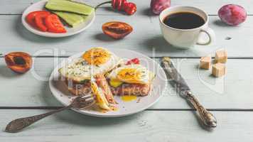 Sandwiches with vegetables and fried egg and cup of coffee