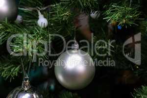 Silver balls hang on the Christmas tree