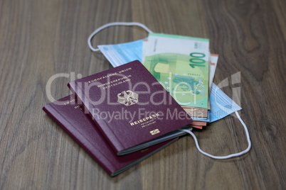 Passport with money and mouth and nose protection mask