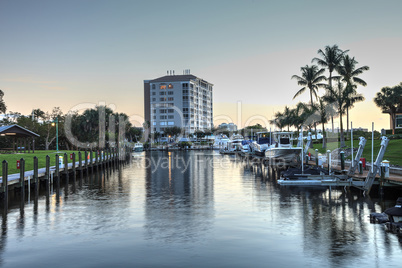 Cocohatchee River Park Marina boats lined up at sunset