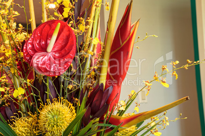 Tropical bouquet of flowers including Heliconia bihai, yellow on
