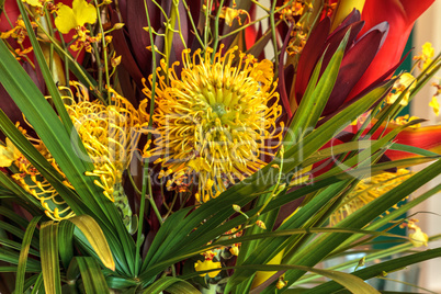 Tropical bouquet of flowers including Heliconia bihai, yellow on