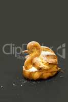 Flaky cream puff dessert in the shape of a swan