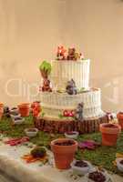 White chocolate birthday cake or wedding cake with forest animal