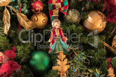 Nutcracker ornament hanging on a Christmas tree