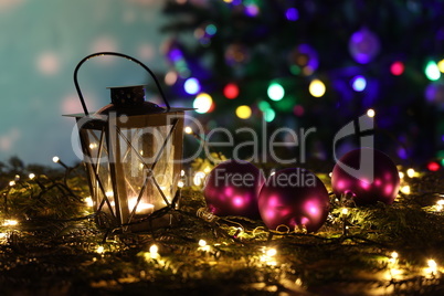 Christmas still life with bright Christmas garlands and a luminous lantern