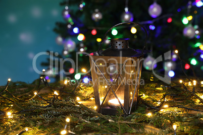 Christmas still life with bright Christmas garlands and a luminous lantern
