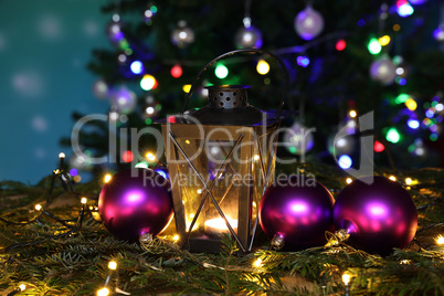 Christmas still life with bright Christmas garlands and a luminous lantern