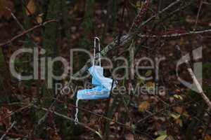 Used medical mask on a tree during the pandemic
