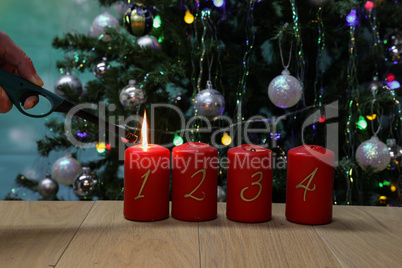 Red Advent candles are lit with a lighter