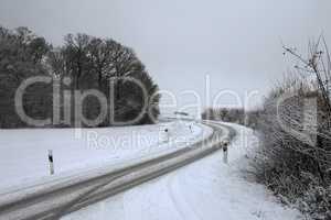 Dangerous turn on a slippery snowy road in winter