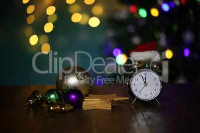 New year composition with alarm clock and beautiful bokeh in the background