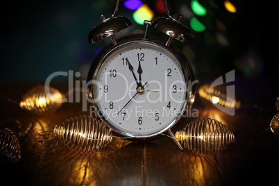 New year composition with alarm clock and beautiful bokeh in the background