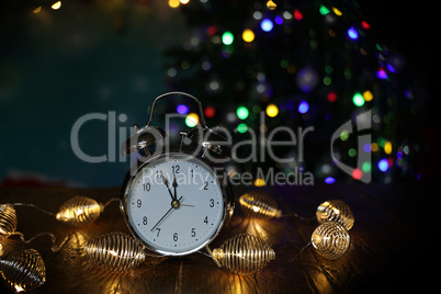 New year composition with alarm clock and beautiful bokeh in the background