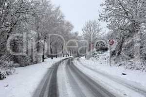 Dangerous turn on a slippery snowy road in winter