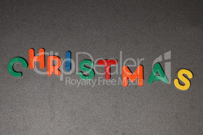 CHRISTMAS - Christmas still life with multicolored plastic letters