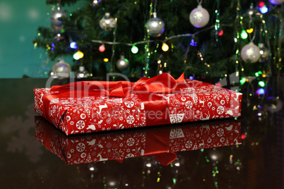 Christmas gift wrapped in bright paper and lies on the table