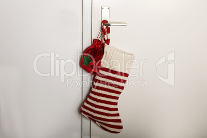 Christmas sock with red stripes for Christmas gifts hanging on the door