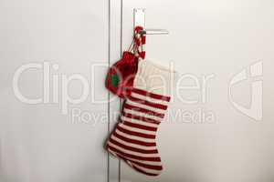 Christmas sock with red stripes for Christmas gifts hanging on the door