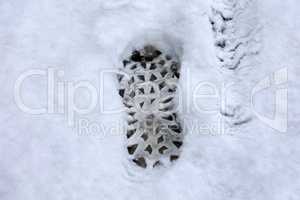 Shoe print on freshly fallen white snow