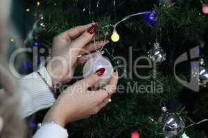 Beautiful Christmas balls are hung on the tree