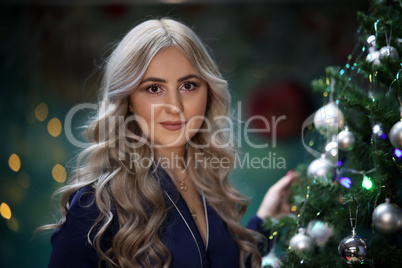Portrait of a young girl by the christmas tree