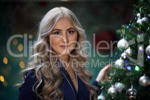 Portrait of a young girl by the christmas tree