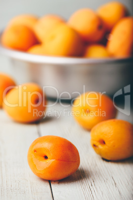 Mellow apricots over light wooden surface