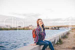 Smiling woman sitting on the riverbank