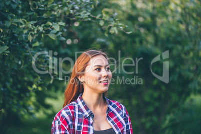 Smiling woman standing in the park