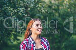 Smiling woman standing in the park