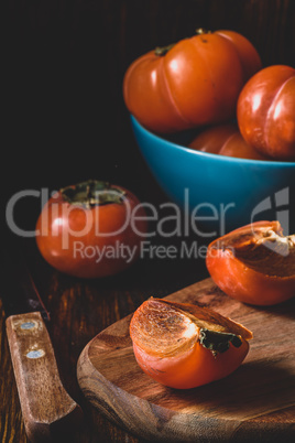 Slices of persimmon on cutting board